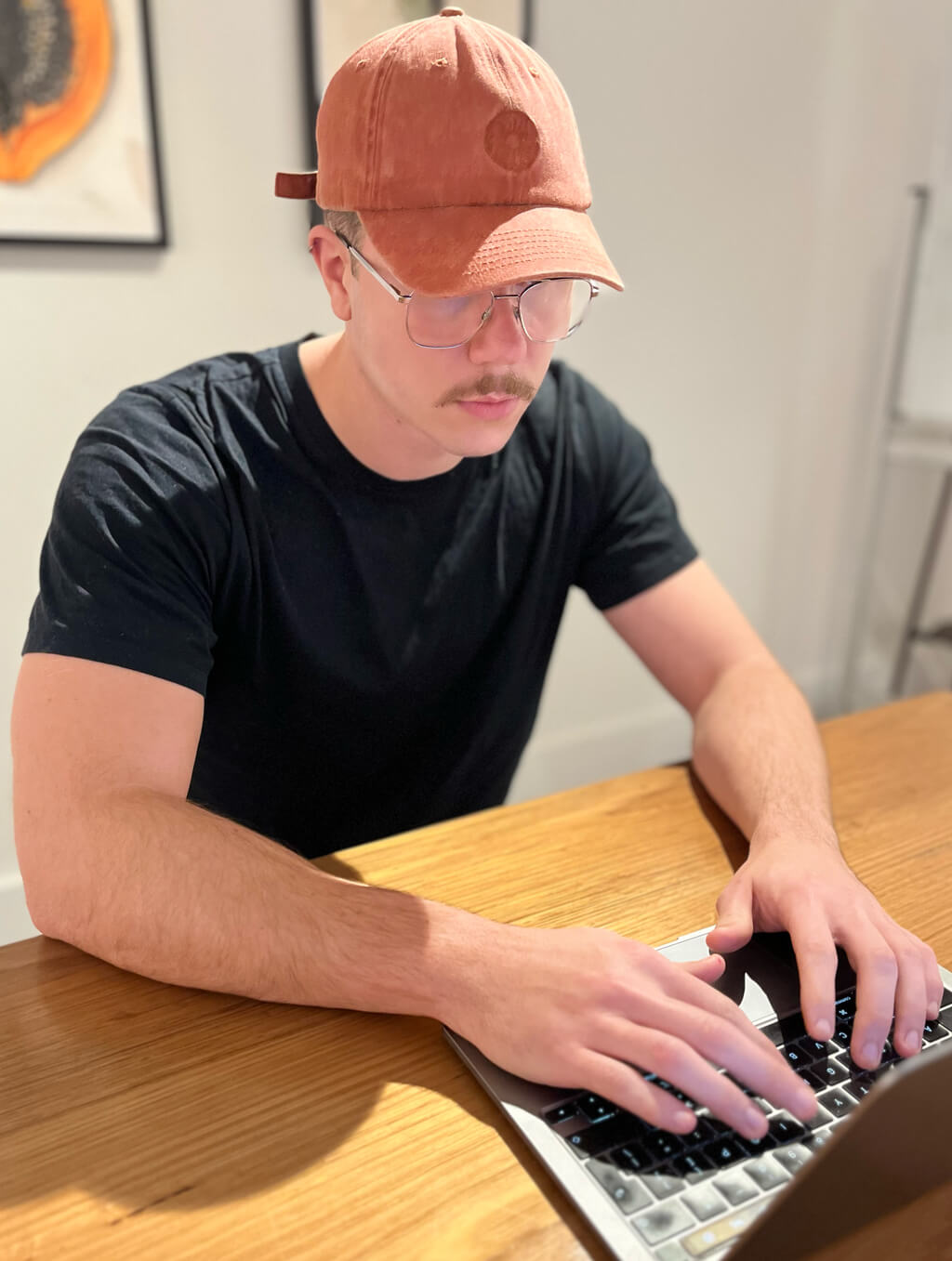 Image of Jack Christian typing on website code on his laptop